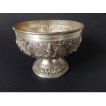 An Indian white metal pedestal sugar bowl, embossed figural panels, 3.75" diameter