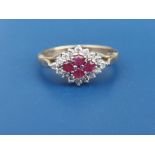 A modern 9ct gold ruby & diamond set lozenge cluster ring. Finger size N.