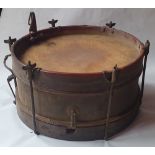 An antique brass-mounted wooden drum with painted decoration, 15.5" diameter.