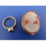 An oval cameo brooch/pendant and a green stone 9ct ring. (2)
