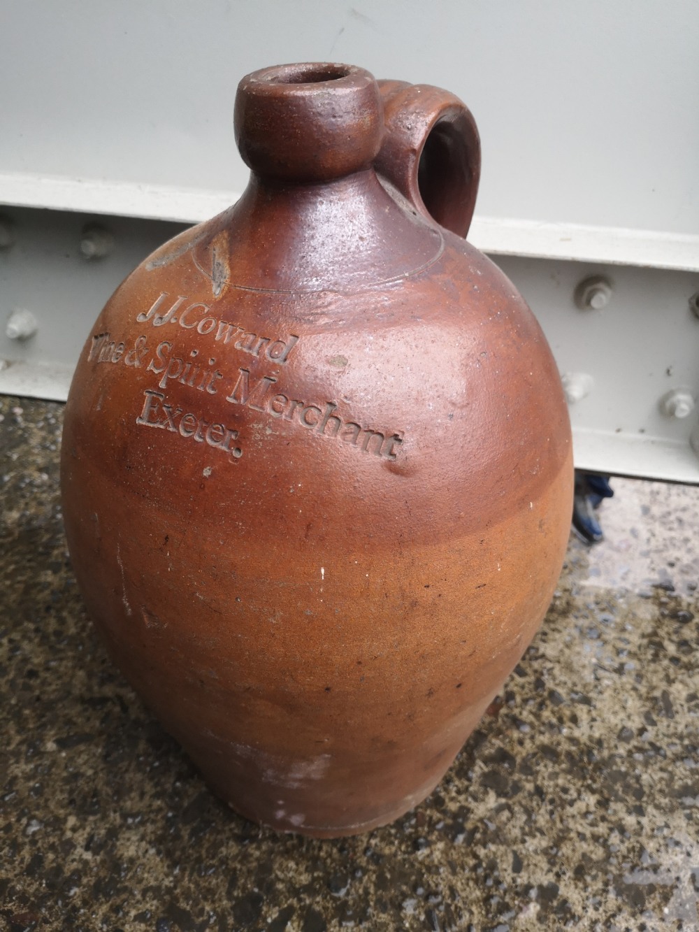 An old stoneware cider jar -'J.J. Coward, Wine & Spirit Merchant, Exeter', 14" high.