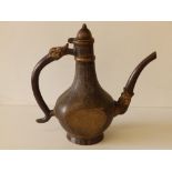 A Persian bronze coffee pot with overall engraved decoration of scrolls and script, 11" high.