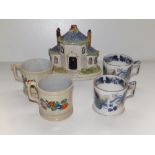 A Victorian Staffordshire cottage pastille burner, a pair of Victorian Davenport ivy wreath mugs and