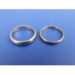 A 22ct gold wedding ring and an 18ct wedding ring. (2)