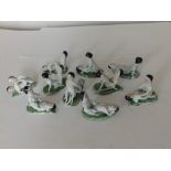A group of ten erotic porcelain figure groups, approximately 3" across. (10)
