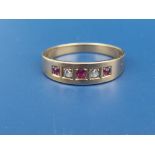 An 18ct gold band ring set with two small rose cut diamonds and three rubies. Finger size N.