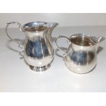 A small silver cream jug - Birmingham 1923, 3.6" high and a smaller modern London silver jug. (2)