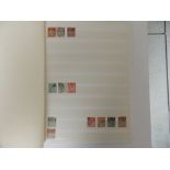 A stock album containing mainly GB QEII stamps, but also two Penny Reds.