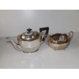 A small oval Birmingham silver half-reeded teapot, 8" across handle and a London silver two-