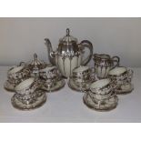A German Koenigszelt porcelain coffee set for 12 with silver mounts and onlaid decoration,