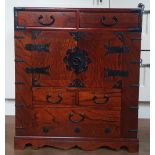 An Oriental table-top cabinet with iron mounts, 23" high, 20.25" wide.