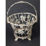 An early Victorian silver openwork swing-handled sweetmeat basket frame decorated with flowering