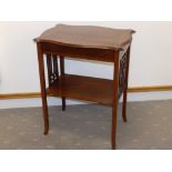 An Edwardian inlaid mahogany two-tier table, with two rectangular fret pattern panels to ends, on