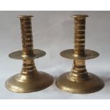 A pair of 17thC brass trumpet base candlesticks, each inscribed on the base with owner's initials,