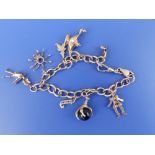 A 9ct charm bracelet with nine charms.