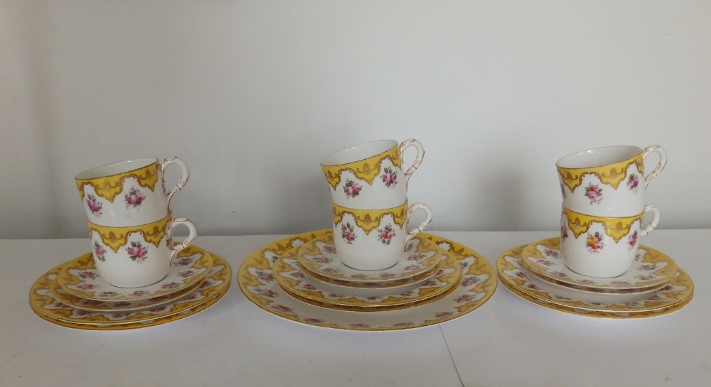 An early 20thC Royal Worcester 19 piece tea set, decorated roses with yellow & gold borders in