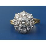 A diamond claw set cluster ring on 18ct shank. Finger size H.