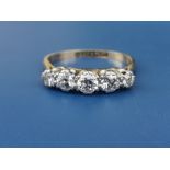 A five stone graduated claw set diamond ring, the central stone weighing approximately 0.20