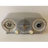 A 1950's/60's Zenith Deluxe grey finish bakelite radio, 12.5" across.