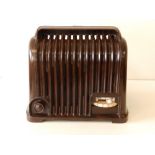 A Sobell radio in fluted brown bakelite case, 8.5" across.