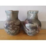 A pair of Oriental celadon glazed vases painted with geese, 9.5" high.