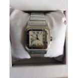 A boxed gent's stainless steel Cartier Santos Galbee quartz bracelet wrist watch with spare link.