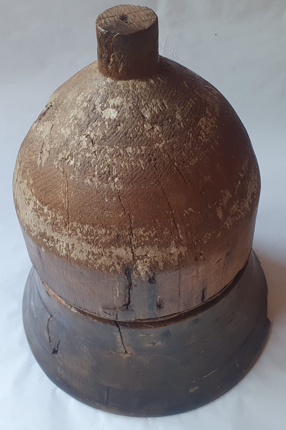 A large two piece wooden form of bell shape, 19" high.