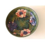 A Moorcroft green ground anemone pattern fruit bowl - 'Potter to H.M. The Queen', 8.6" diameter.