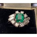 A 1970's certified natural emerald & diamond cluster ring, the central claw set rectangular cut