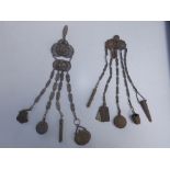 Two Victorian metal chatelaines with attachments including pencils, posy holders, aide memoires, a