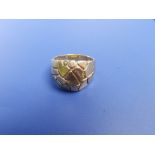 A heavy yellow metal signet style ring decorated with a cracked ice design. Finger size V - tests as