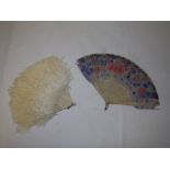 An early 20thC painted feather & bone fan, together with an ostrich feather fan. (2)