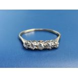 A small five stone diamond ring with buckled yellow metal shank. Finger size N.