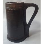 An antique leather blackjack tankard with silver mounts, 8" high.