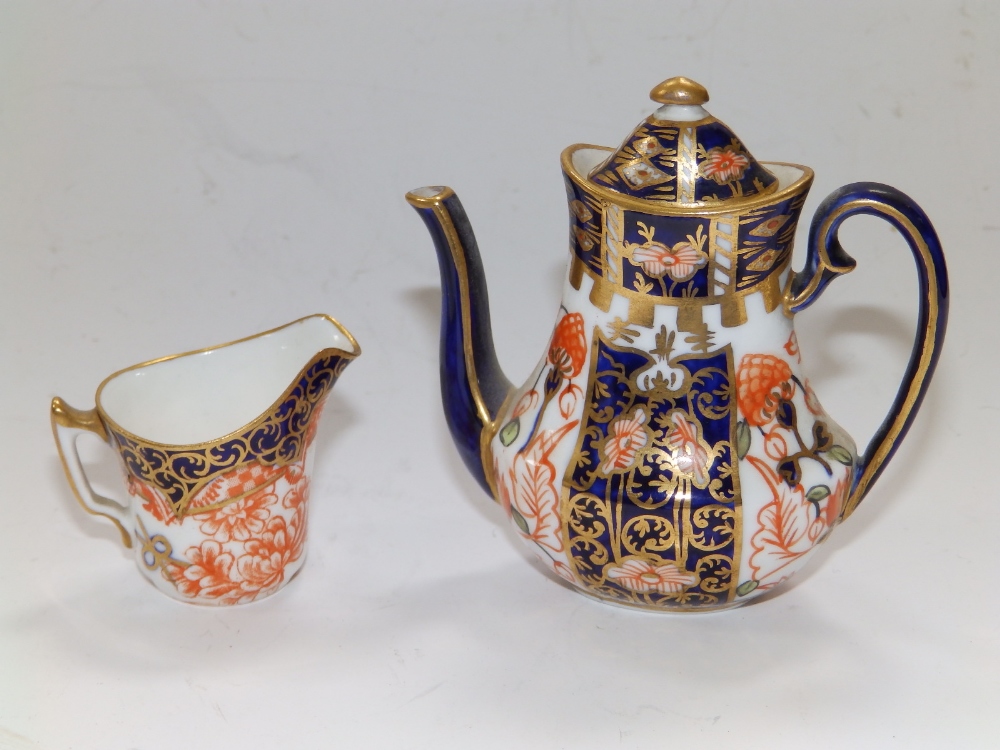 A miniature Royal Crown Derby Imari pattern coffee pot, 3" and a cream jug. (2)