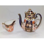 A miniature Royal Crown Derby Imari pattern coffee pot, 3" and a cream jug. (2)