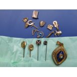 Four Victorian stick pins, an enamelled pendant and 10 small 9ct charms. (15)