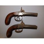 A pair of 19thC boxlock double-barrel pistols, probably Belgian, having 3" octagonal barrels. (2)
