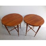 A pair of Chinese circular drop leaf occasional tables, possibly huanghuali, on four-legged
