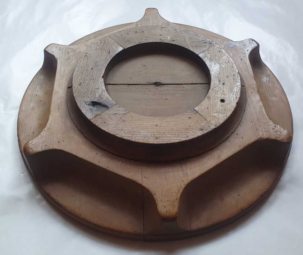 A wooden circular stand (?) stamped 'S.S. HOLMWOOD 1921', 17.5" diameter.