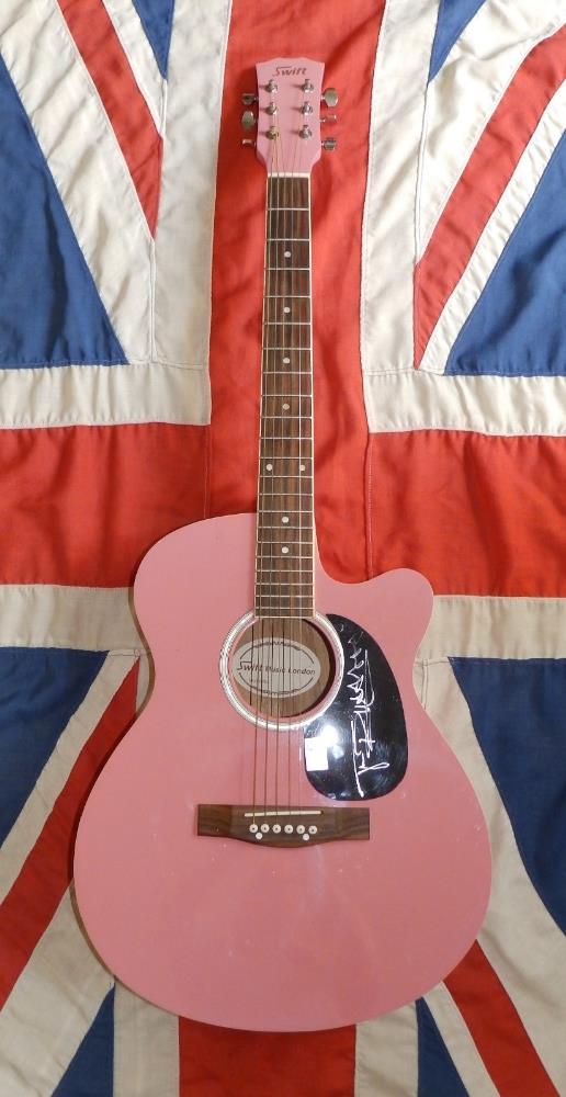 A pink Swift guitar signed in silver by the Sex Pistols' lead singer Johnny Rotten (John Lydon),