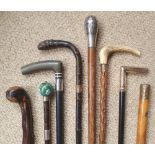 A collection of walking sticks, including silver , niello, cloisonne and yellow metal.