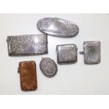 Two Birmingham silver vestas with engraved decoration, a silver card case and three metal items. (