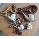 Three cased meerschaum pipes and one other. (4)