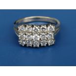 A diamond set 18ct white gold cocktail ring, claw set three rows of small diamonds of total