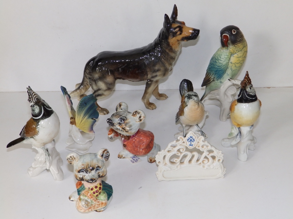 A Goebel porcelain alsatian, 7" high and seven various small animal figures. (8)