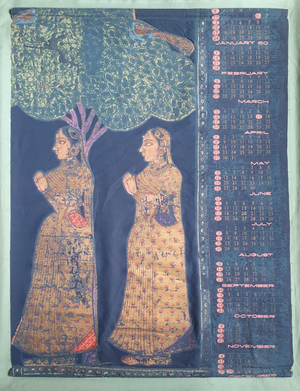 An Indian painted fabric hanging depicting two figures and a 1960's calendar, 31.5" x 24". (2)