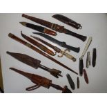 A collection of ethnic knives and other items.