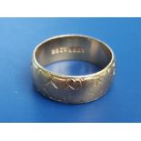 A late 20thC yellow metal band ring having (rubbed) engraved exterior decoration, believed to have