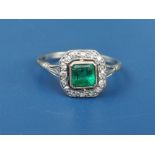An Art Deco period emerald & diamond square cluster ring in platinum. Finger size K.